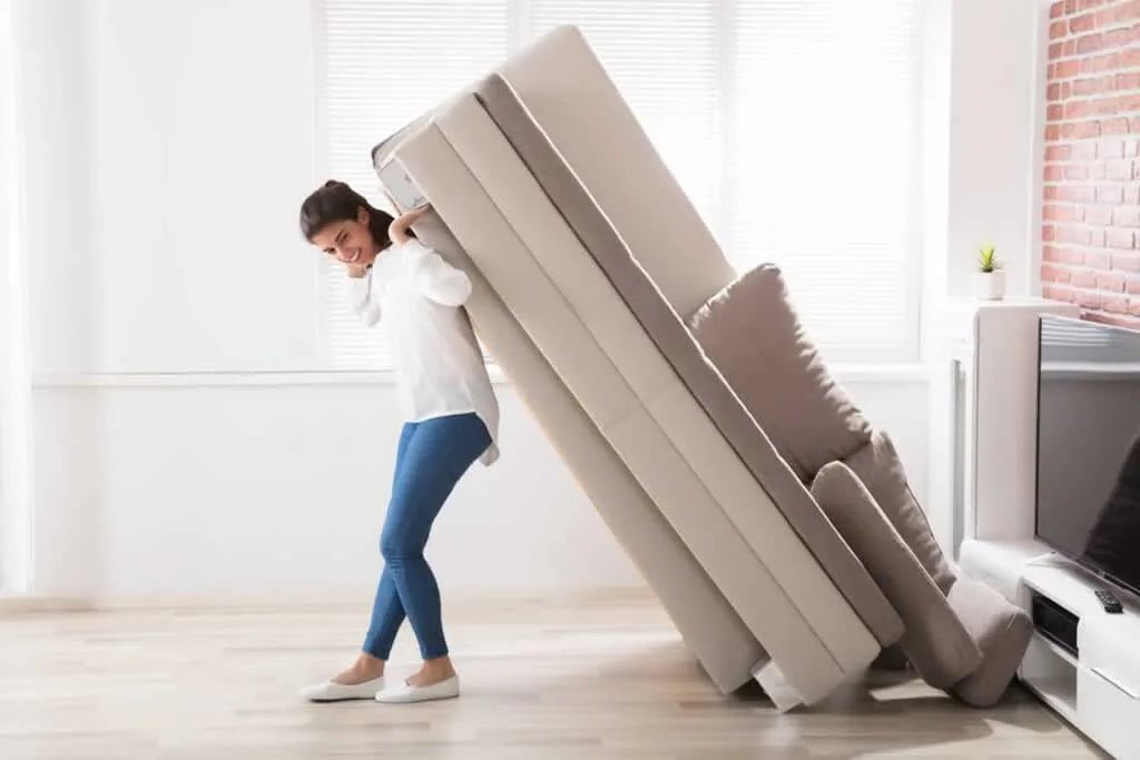 women lifting sofa with her back